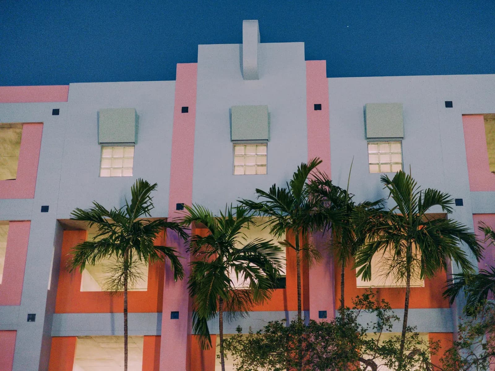 Pastel Art Deco architecture and palm trees in Miami Beach